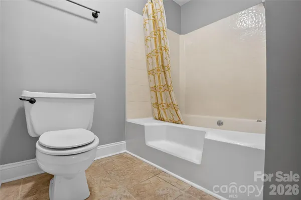 a bathroom with a toilet and a bathtub