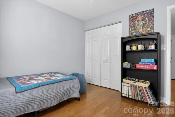a bedroom with a bed and dresser
