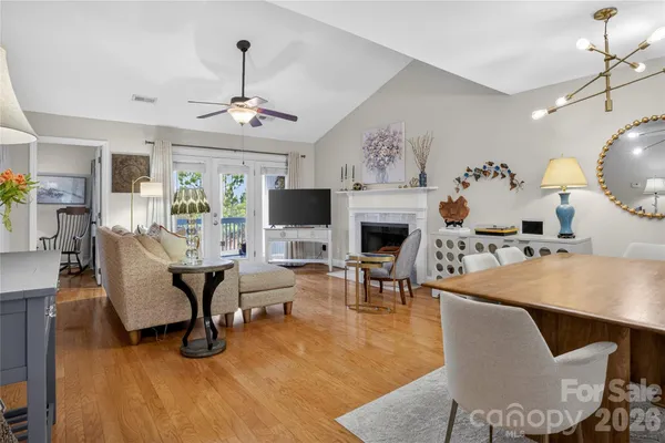 a living room with furniture a fireplace and a chandelier