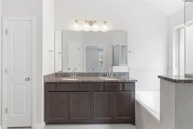 a bathroom with a granite countertop sink a mirror and a vanity