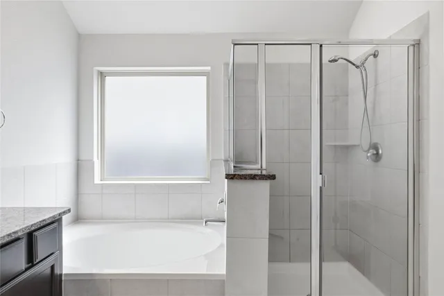 a bathroom with a bathtub and a shower