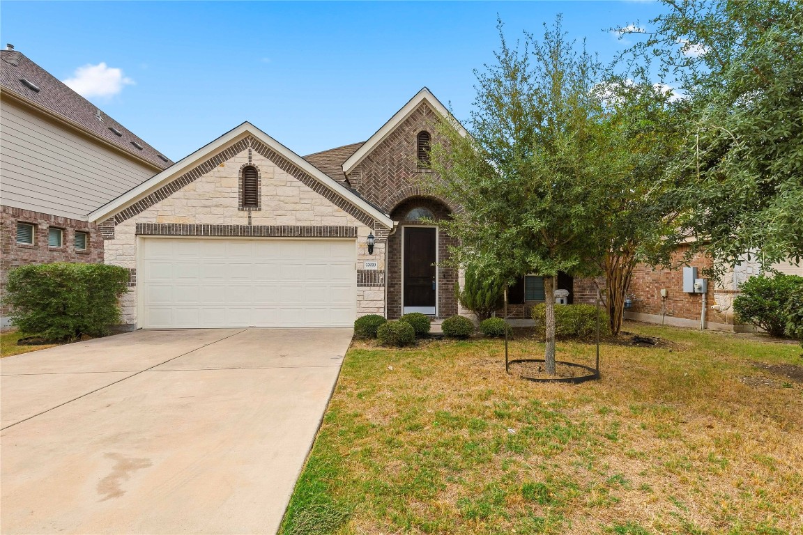 22020 Abigail Way Pflugerville, TX 78660 - Photo 2 of 25 a front view of a house with a yard