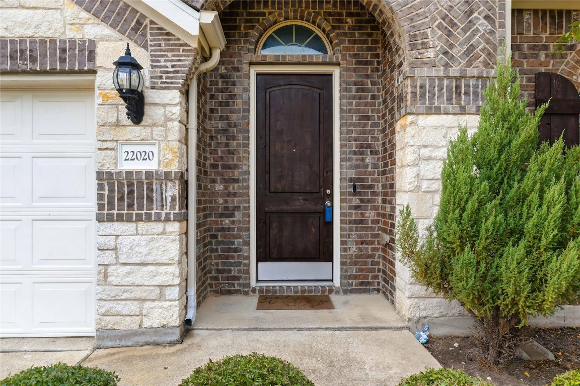 22020 Abigail Way Pflugerville, TX 78660 - Photo 3 of 25 a front view of a house with a yard