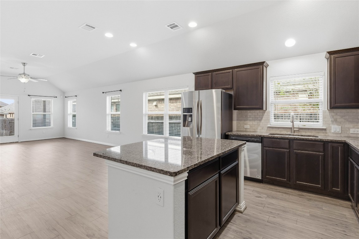 22020 Abigail Way Pflugerville, TX 78660 - Photo 6 of 25 a kitchen with stainless steel appliances granite countertop a sink stove and refrigerator