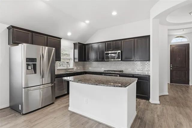a kitchen with a refrigerator sink and microwave