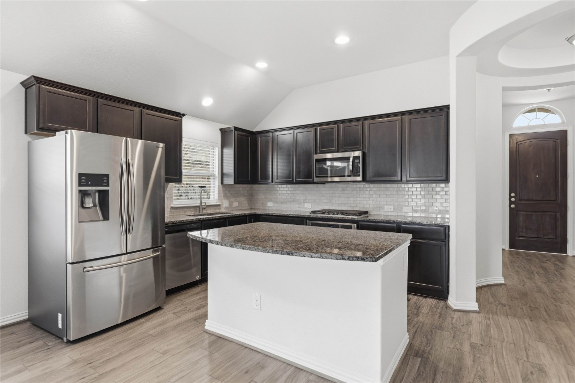 22020 Abigail Way Pflugerville, TX 78660 - Photo 7 of 25 a kitchen with a refrigerator sink and microwave
