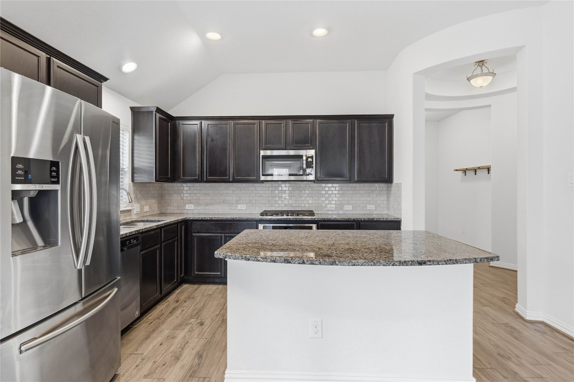 22020 Abigail Way Pflugerville, TX 78660 - Photo 8 of 25 a kitchen with stainless steel appliances granite countertop a refrigerator sink and stove