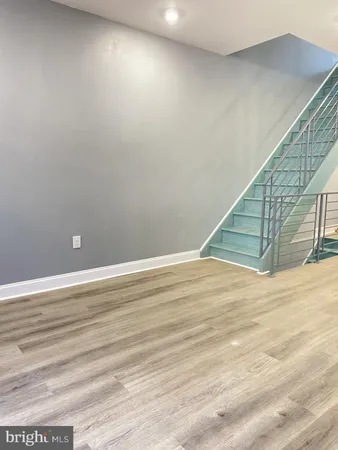 a view of a room with wooden floor