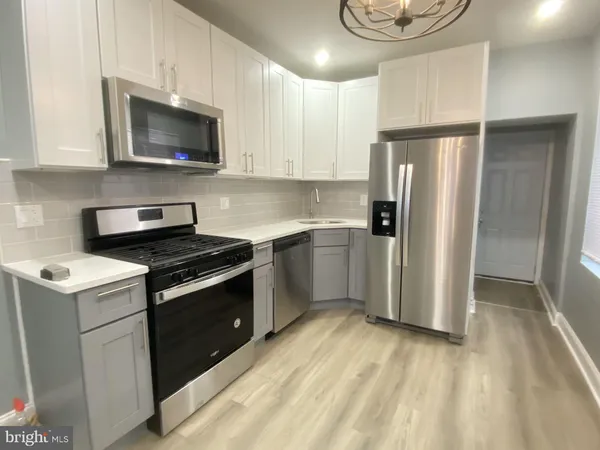 a kitchen with a refrigerator stove and microwave