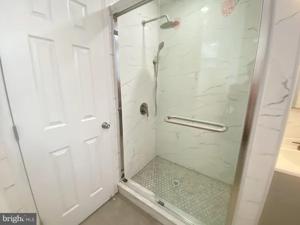 a bathroom with a glass door shower