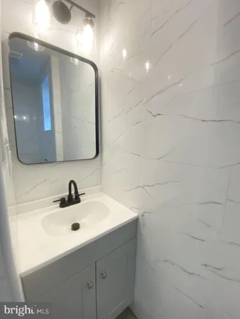 a bathroom with a sink and mirror