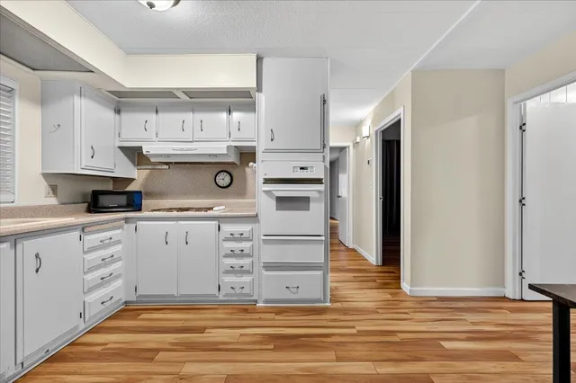 a kitchen with cabinets oven and a dishwasher