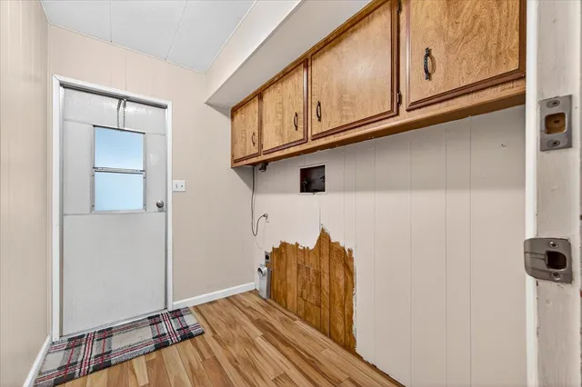 a view of a closet with wooden floor
