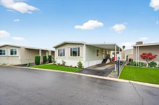 a view of a house with a yard and garage