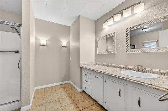 a bathroom with a granite countertop sink mirror and double