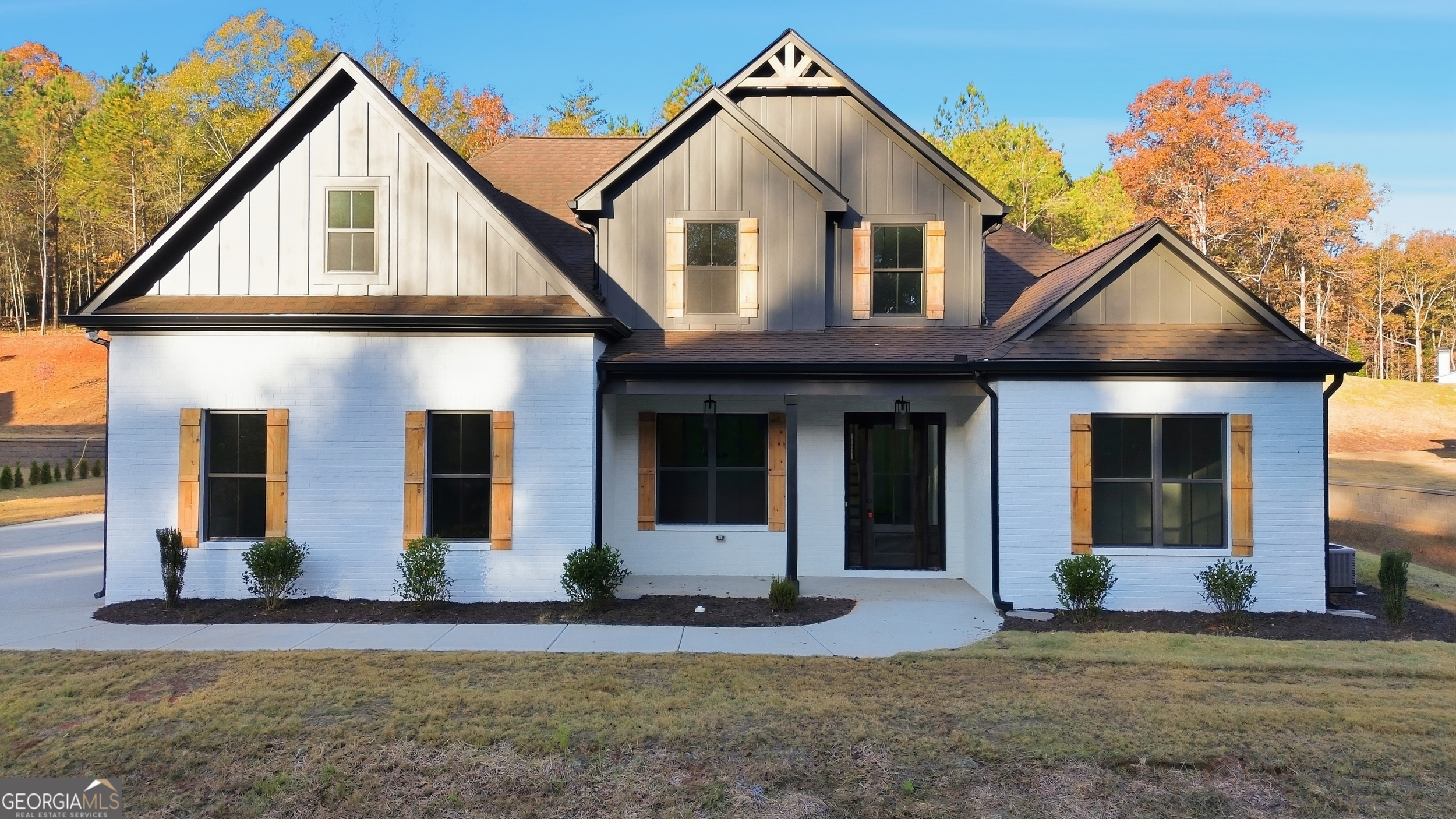 297 Ayers Creek Drive Toccoa, GA 30577 - Photo 1 of 51 a view of a white house with large windows and a small yard