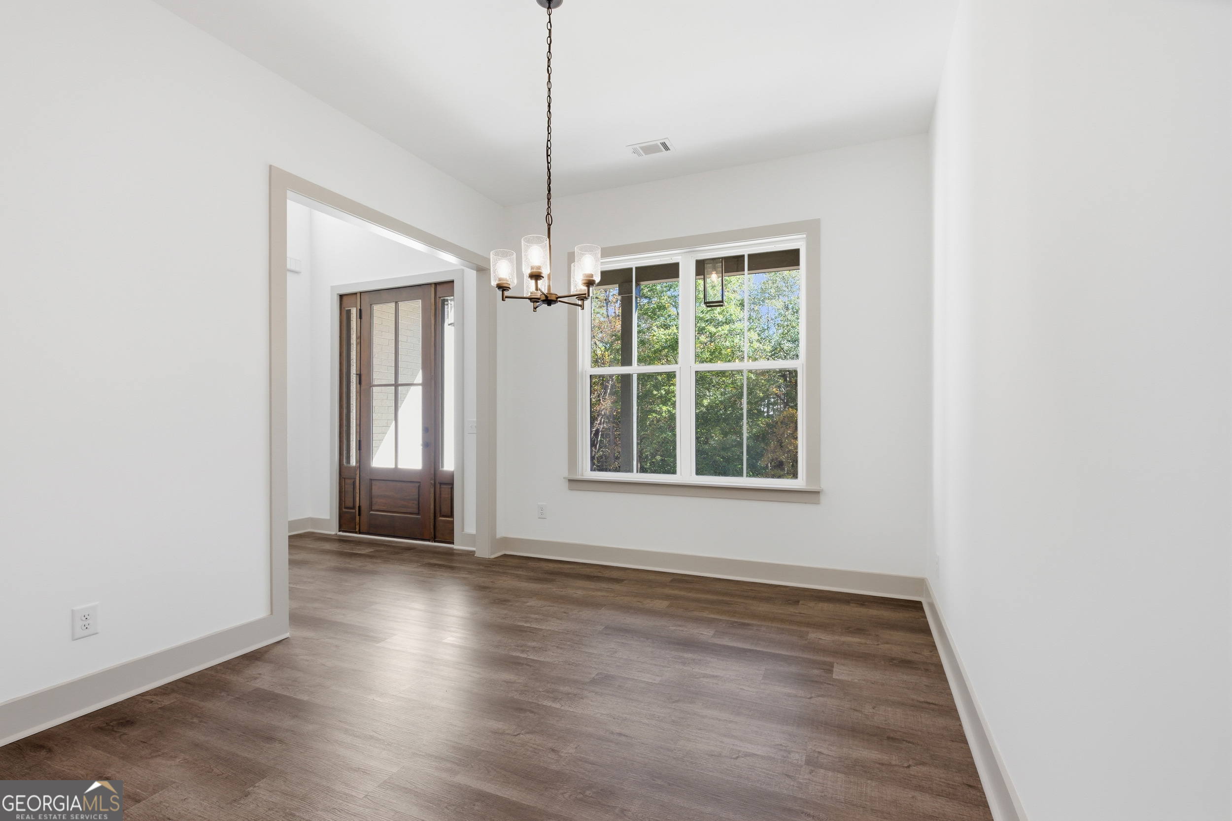 297 Ayers Creek Drive Toccoa, GA 30577 - Photo 16 of 51 a view of an empty room with wooden floor fridge and a window