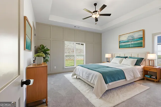 an empty room with windows and fan