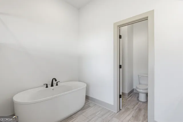 a white toilet sitting next to a bathroom sink