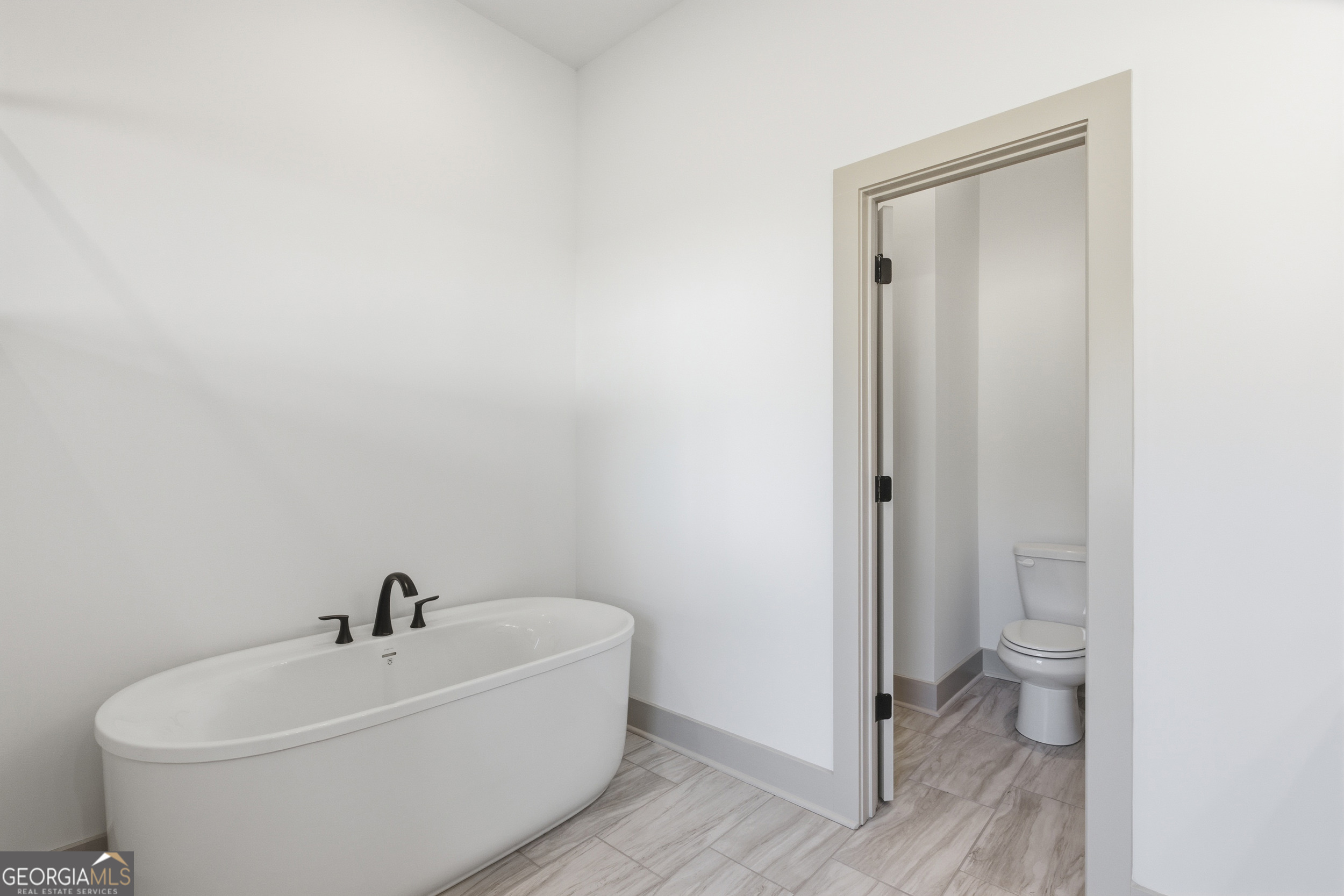 297 Ayers Creek Drive Toccoa, GA 30577 - Photo 24 of 51 a white toilet sitting next to a bathroom sink