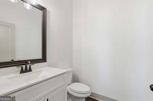 a view of an empty room and wooden floor