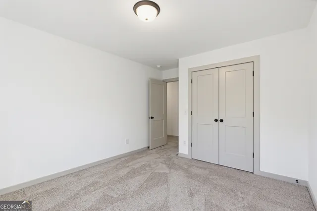 a living room with furniture and a book shelf