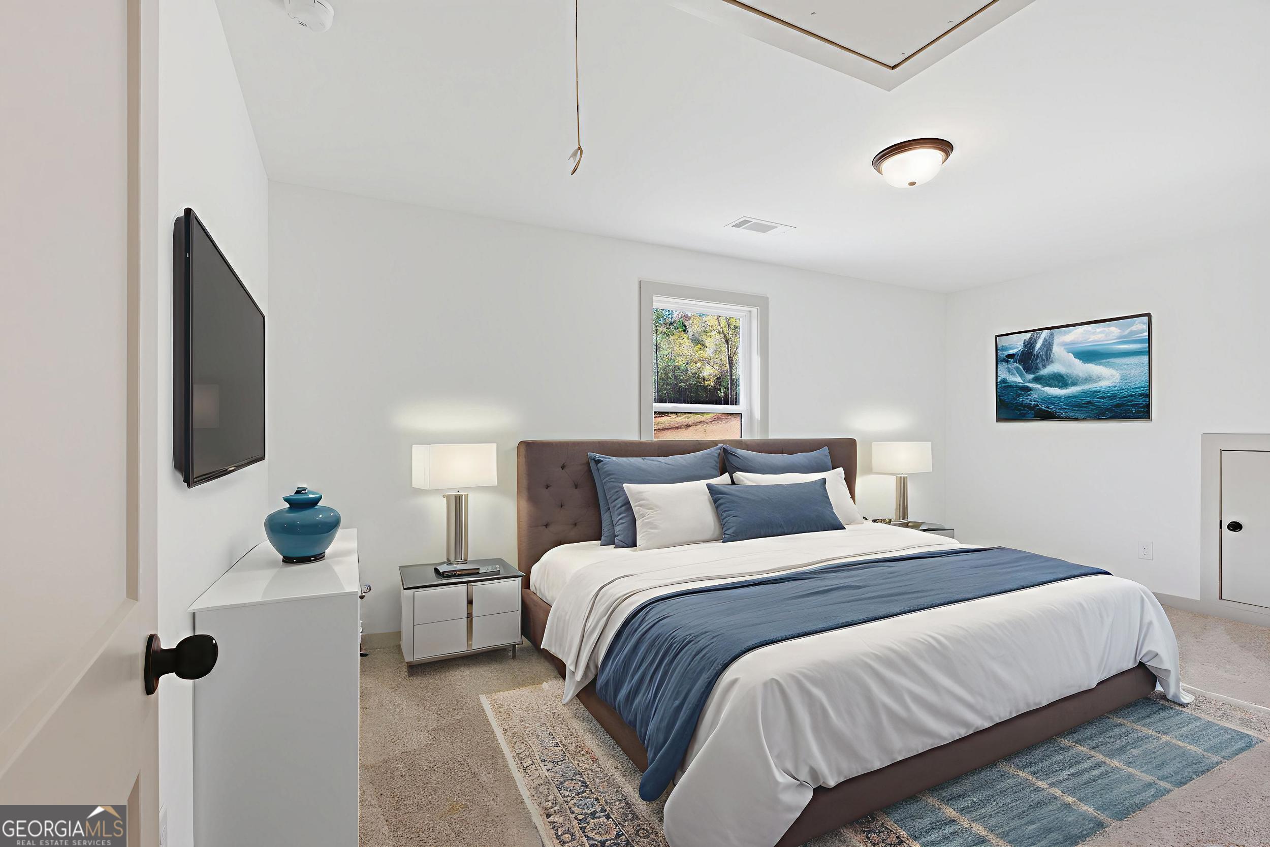 297 Ayers Creek Drive Toccoa, GA 30577 - Photo 38 of 51 a bedroom with a bed and a flat screen tv