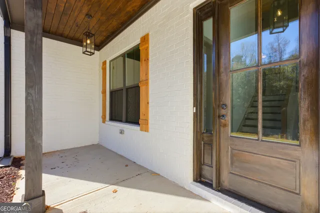 a view of a hallway with wooden floor and entryway