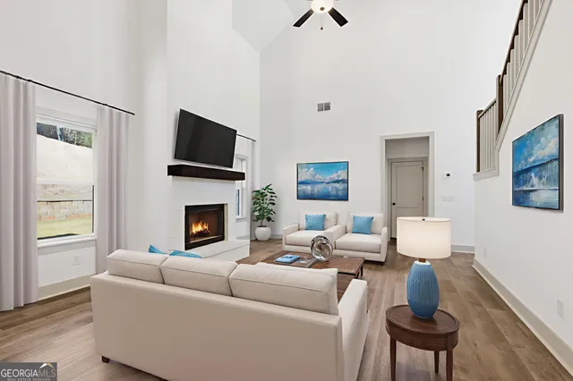 an empty room with windows and a fireplace