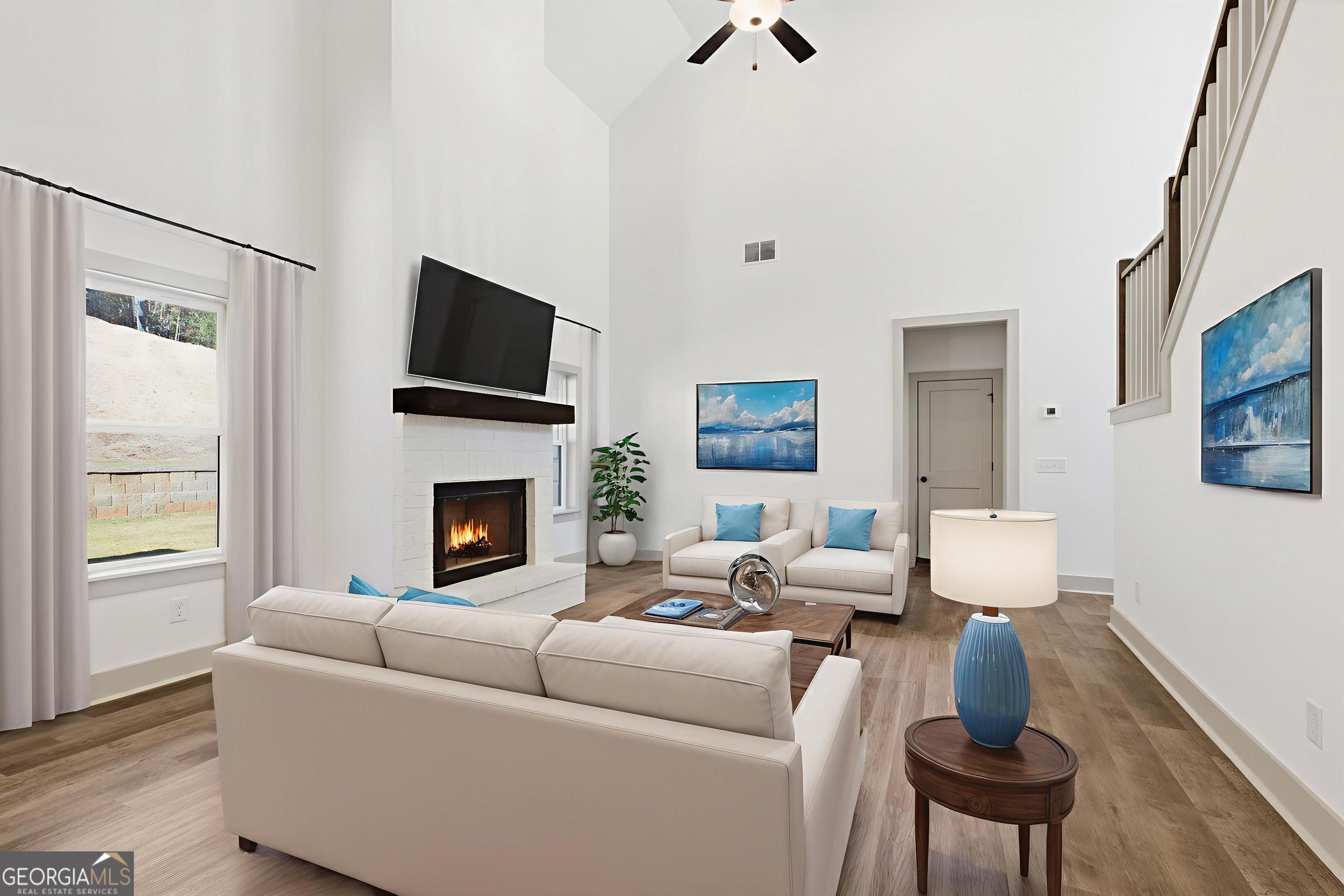 297 Ayers Creek Drive Toccoa, GA 30577 - Photo 8 of 51 a living room with furniture a flat screen tv and a fireplace