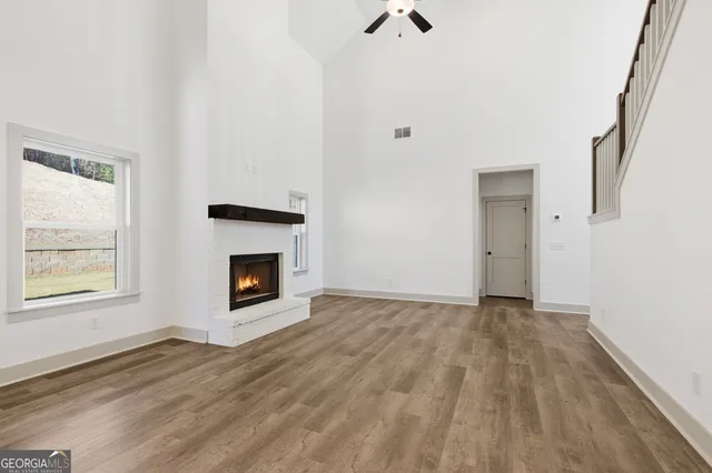 a kitchen with stainless steel appliances kitchen island a refrigerator a stove a sink and a wooden floor