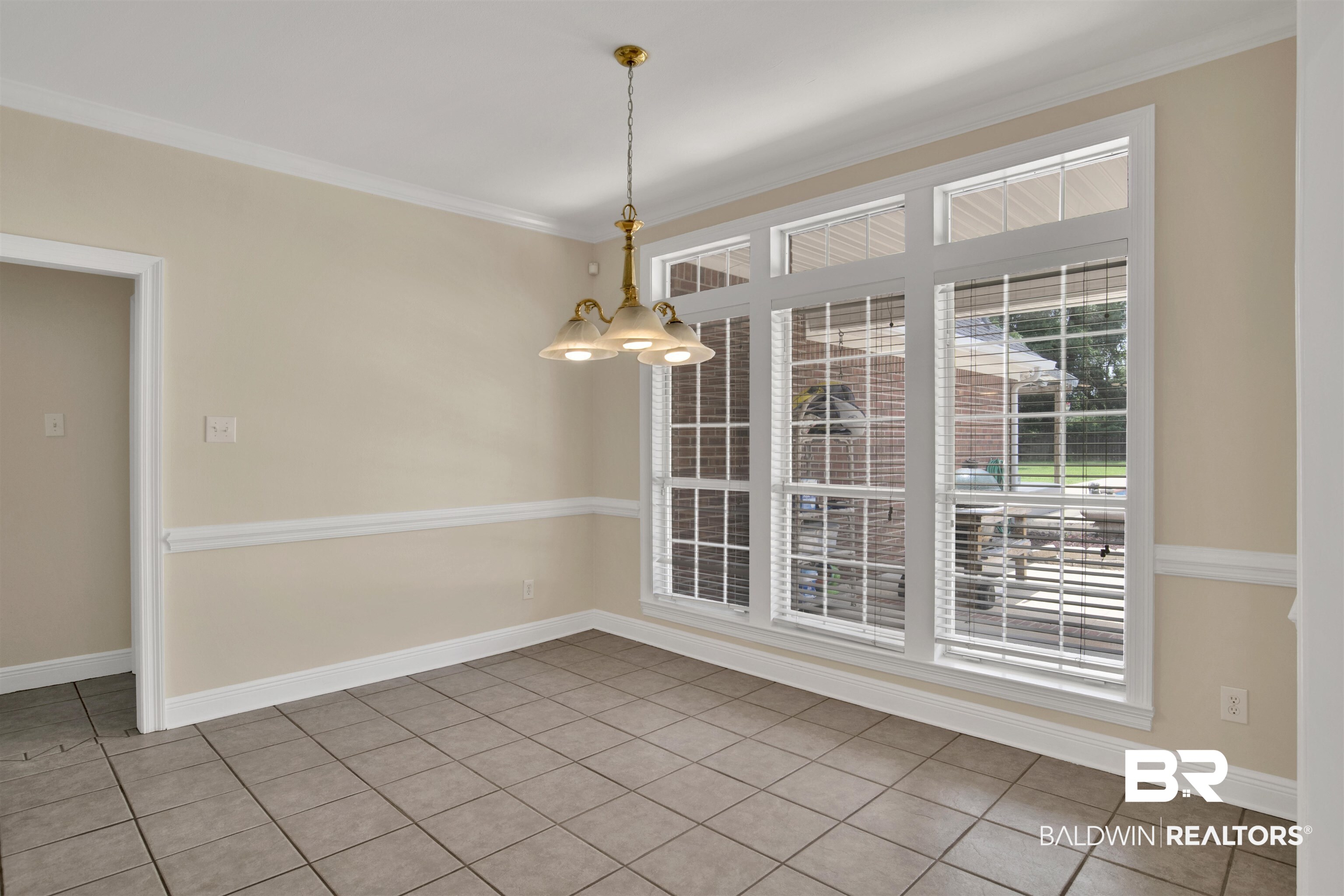 8847 Dawes Lake Road South Mobile, AL 36619 - Photo 6 of 47 Tiled flooring with an overhead chandelier, crown molding, and chair rail detailing