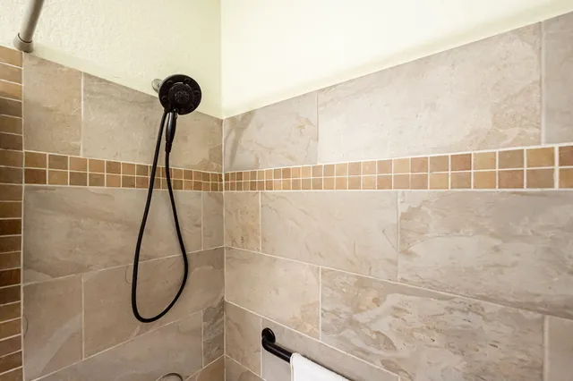 a view of a hallway with wooden floor and a living room