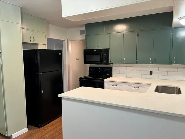 a kitchen with stainless steel appliances a refrigerator and a sink