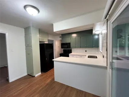 a white refrigerator freezer sitting inside of a kitchen