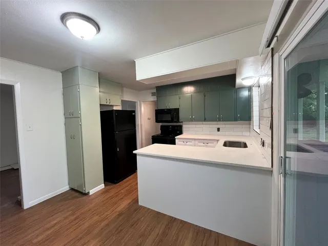 a white refrigerator freezer sitting inside of a kitchen