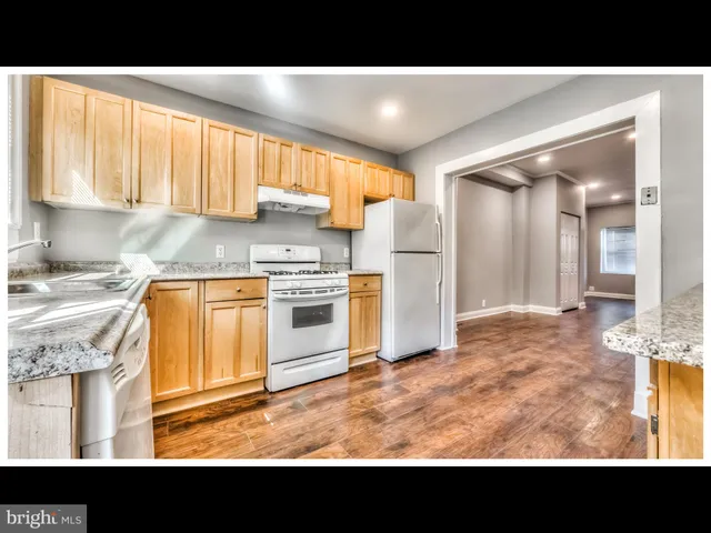 a open kitchen with a sink window and cabinets