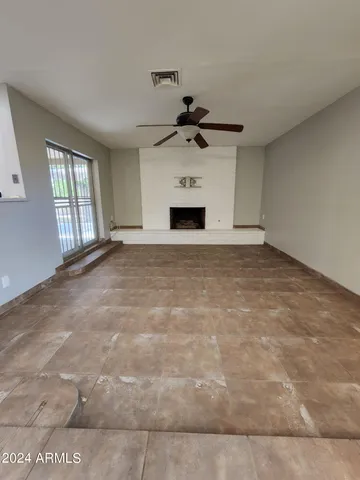 a view of empty room with a fireplace