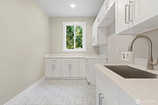 a large white kitchen with a large window