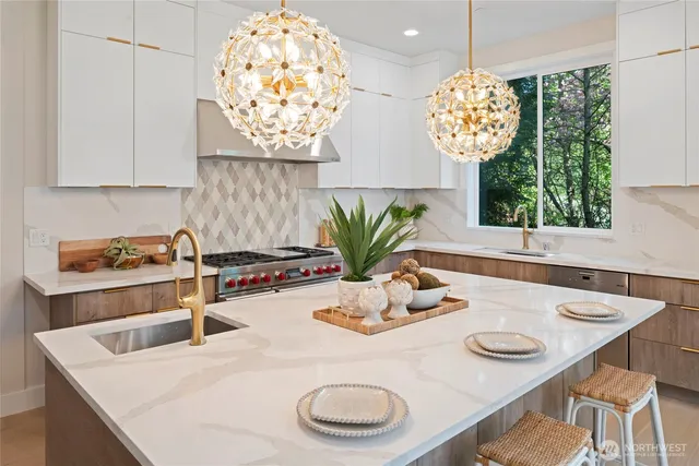 a kitchen with white cabinets and window