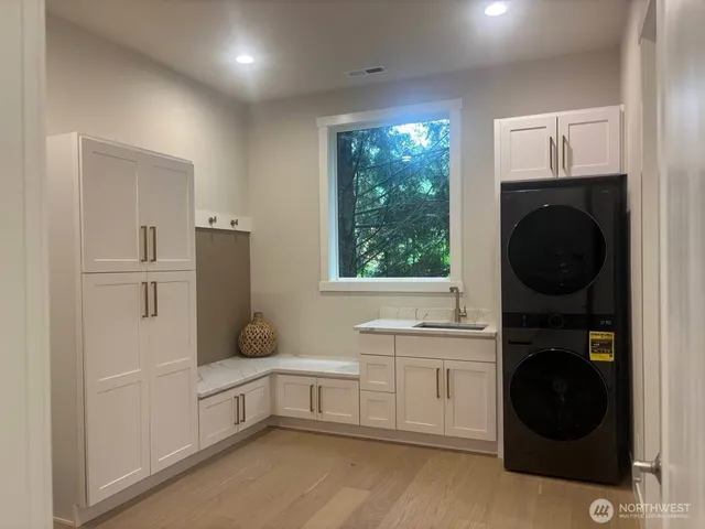 a dining room with furniture a window and wooden floor