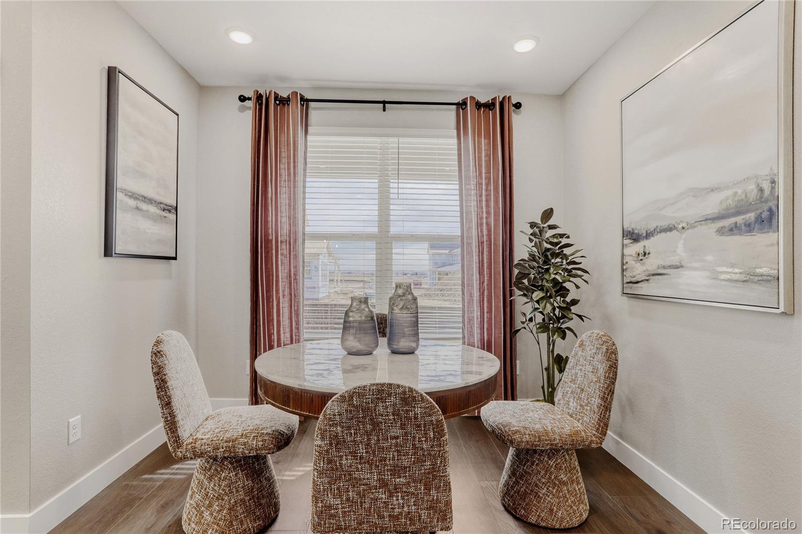 5386 Starling Way Firestone, CO 80504 - Photo 13 of 28 a dining room with furniture and wooden floor