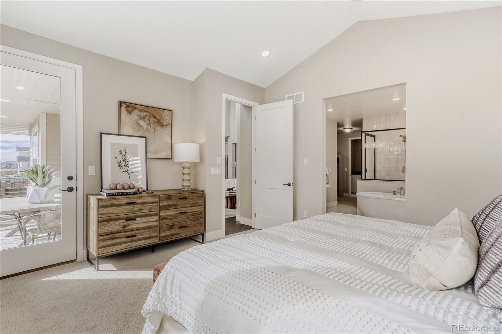 5386 Starling Way Firestone, CO 80504 - Photo 17 of 28 a bedroom with a bed and a mirror