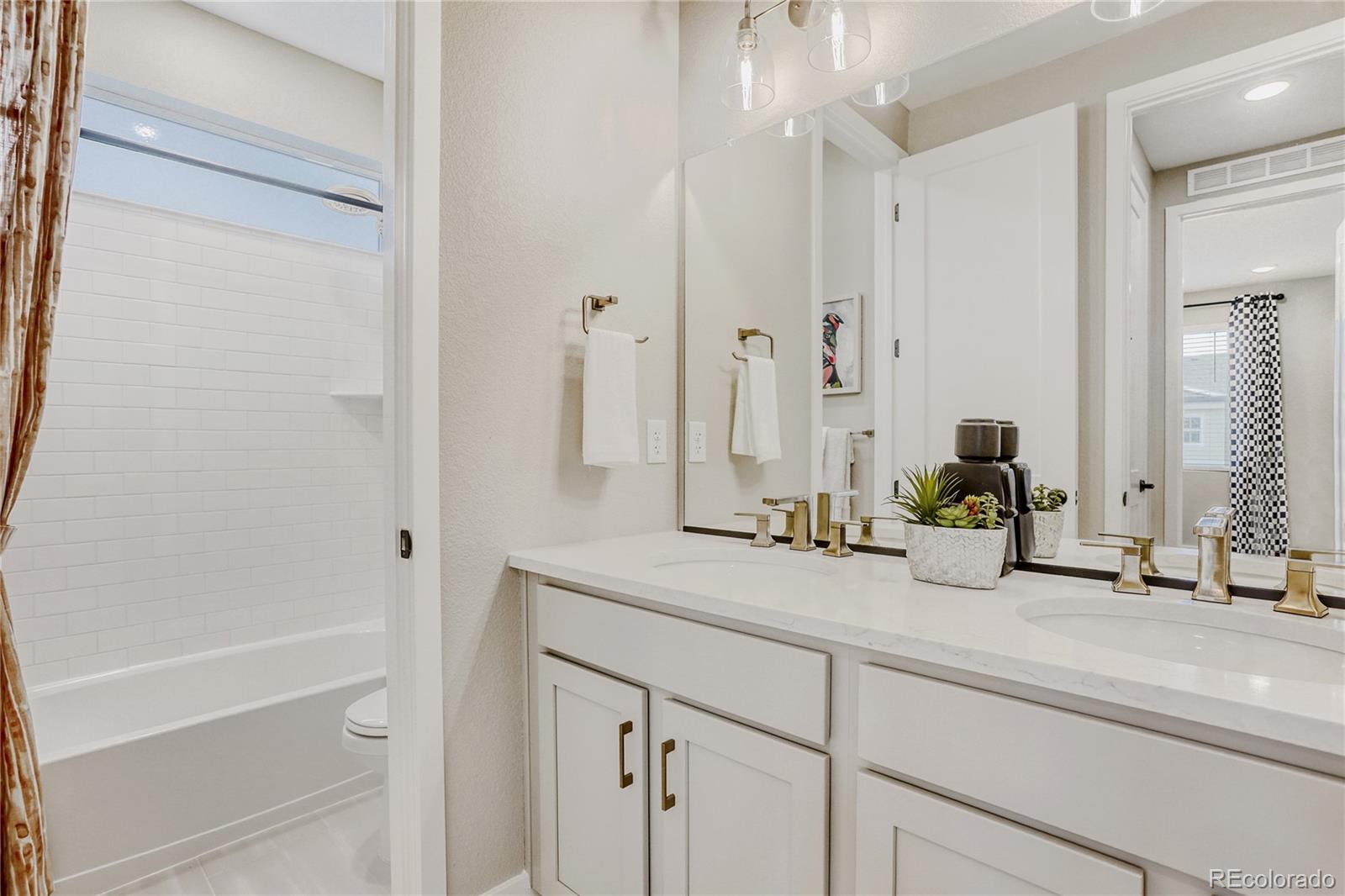 5386 Starling Way Firestone, CO 80504 - Photo 23 of 28 a bathroom with a sink and a mirror