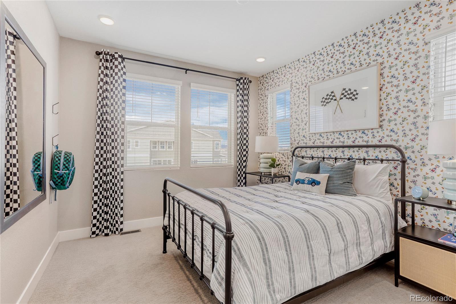 5386 Starling Way Firestone, CO 80504 - Photo 24 of 28 a bedroom with a bed and a painting on the wall