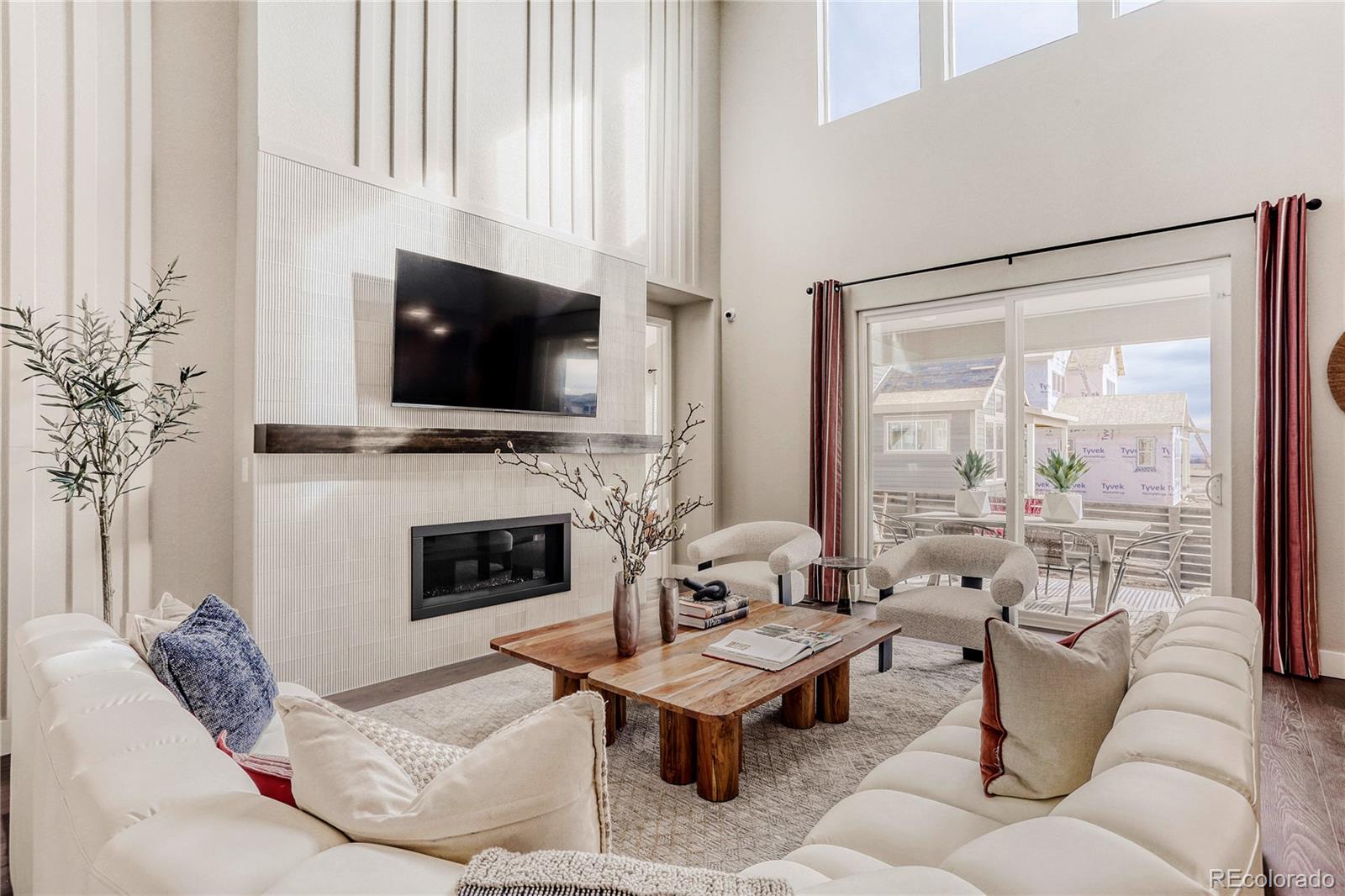 5386 Starling Way Firestone, CO 80504 - Photo 7 of 28 a living room with furniture a fireplace and a flat screen tv