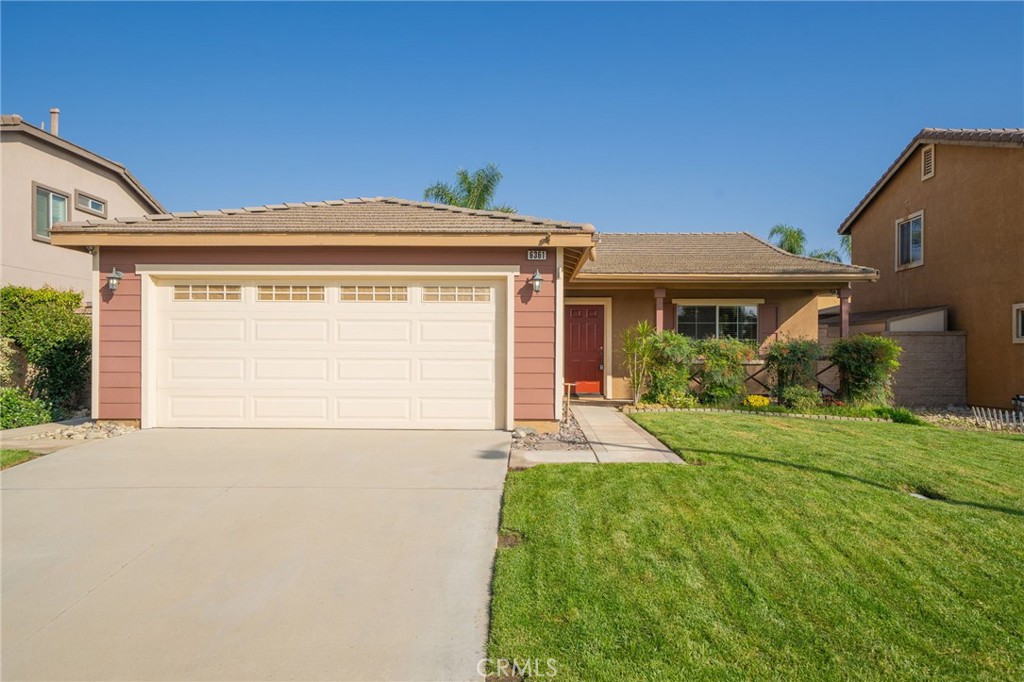 6361 Pintail Way Fontana, CA 92336 - Photo 1 of 32 a front view of a house with a yard and garage