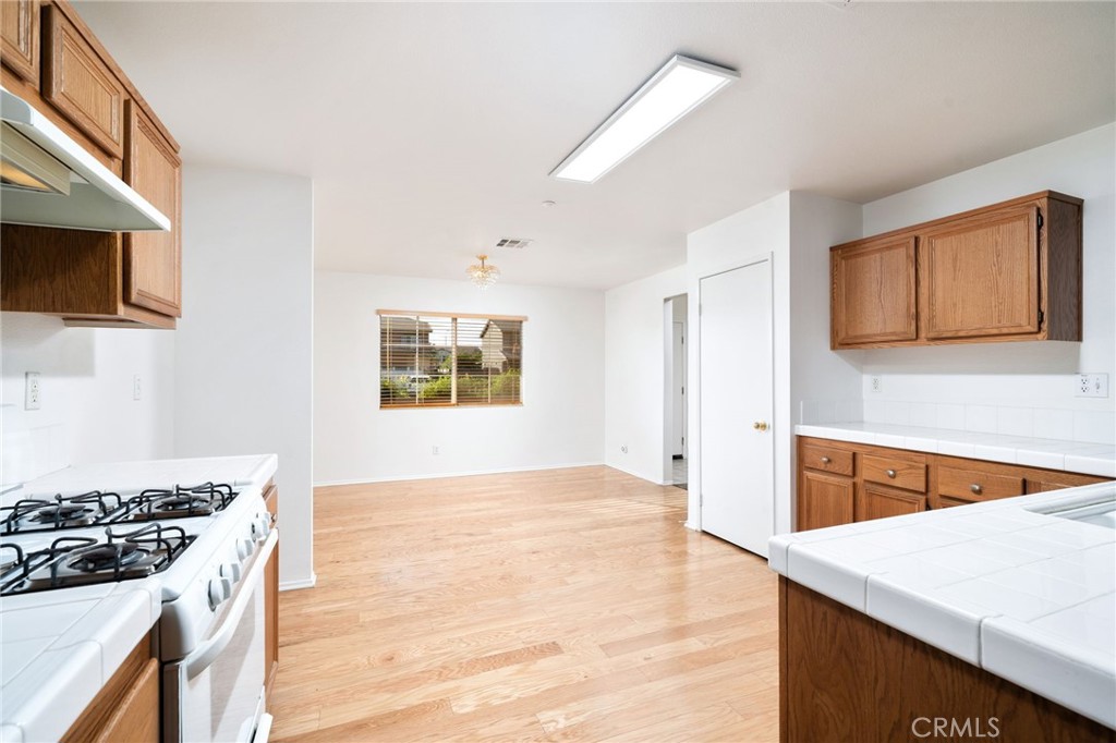 6361 Pintail Way Fontana, CA 92336 - Photo 11 of 32 a kitchen with stainless steel appliances granite countertop a stove a sink and a microwave