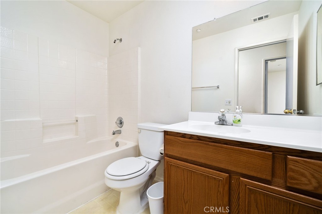 6361 Pintail Way Fontana, CA 92336 - Photo 14 of 32 a bathroom with a sink a toilet and shower