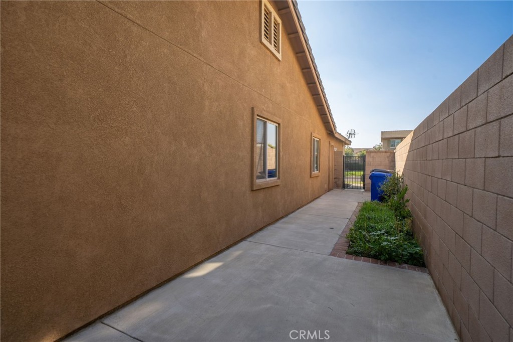6361 Pintail Way Fontana, CA 92336 - Photo 26 of 32 a view of a pathway of a house with a street